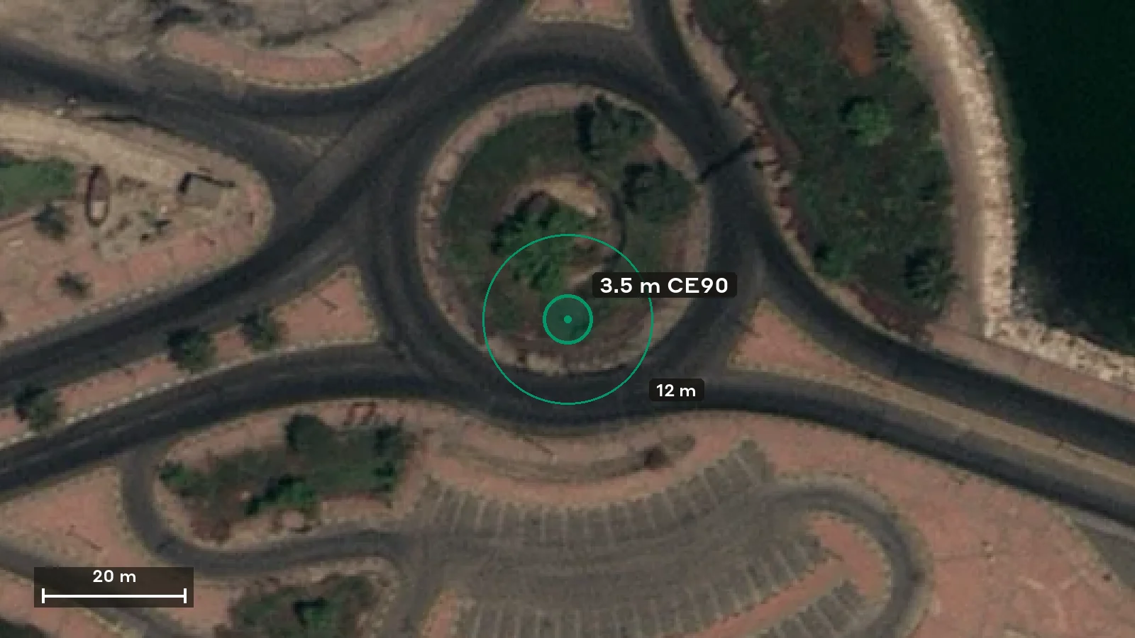 A 3.5 m CE90 positional error circle and a 12 m circle drawn to scale over 30 cm satellite imagery of a roundabout in Darin, Saudi Arabia, with a 20 m scale bar