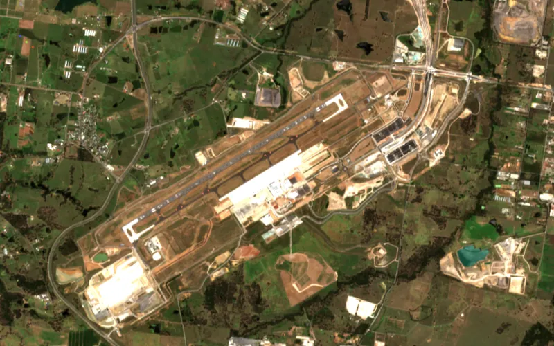 Sentinel-2 image of the Western Sydney International Airport site, Dec 2024: Terminal and apron buildings rising beside the runway.