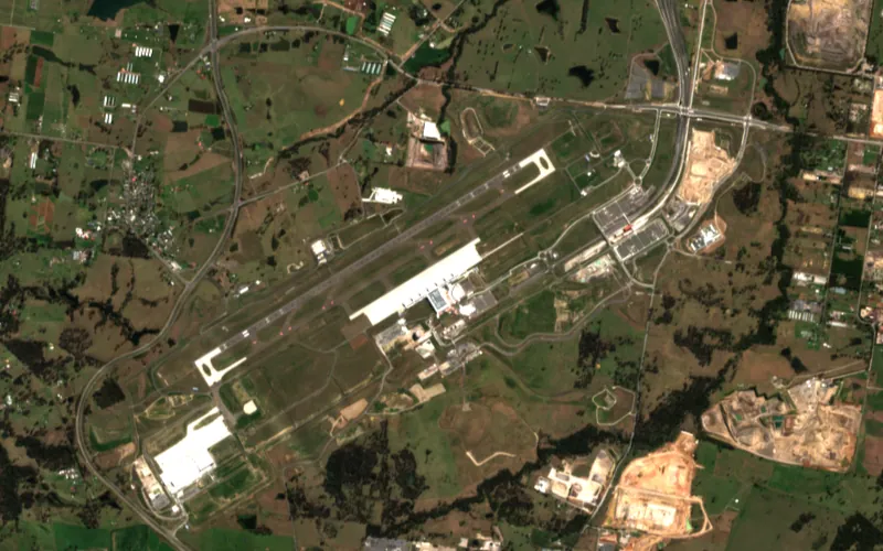 Sentinel-2 image of the Western Sydney International Airport site, Aug 2026: Runway, terminal, aprons and road links in place.